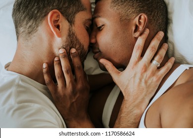 Gay Couple Cuddling In Bed