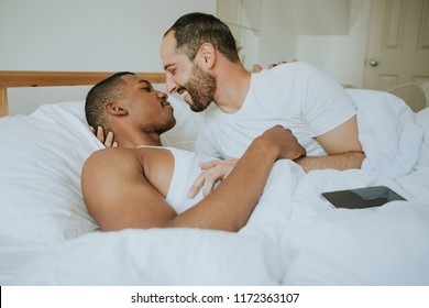 Gay Couple Cuddling In Bed