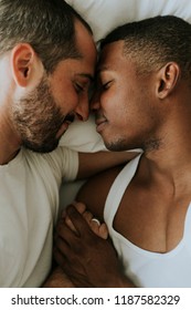 Gay Couple Cuddling In Bed