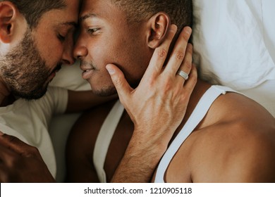 Gay Couple Cuddling In Bed