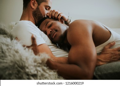 Gay Couple Cuddling In Bed