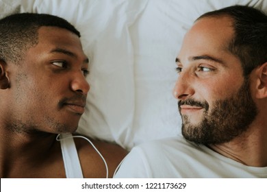 Gay Couple Cuddling In Bed