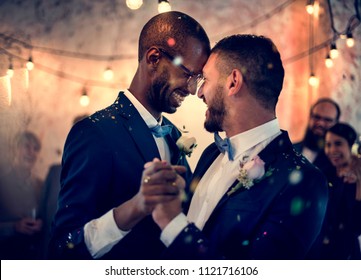 Gay couple dancing on wedding day