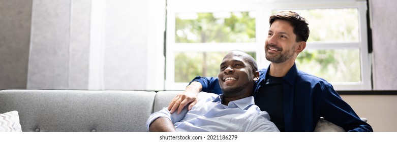 Gay Couple Dreaming On Couch. Thinking About House