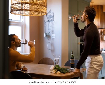 Gay couple drinking red wine at home - Powered by Shutterstock