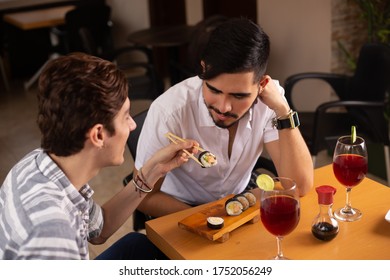 Gay Couple Eating Sushi In A Restaurant