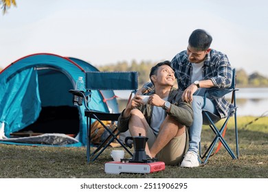 Gay couple embracing at scenic lakeside campsite - Powered by Shutterstock