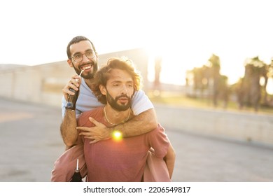 Gay Couple Embracing And Showing Their Love. Young Men Drinking Juice.	