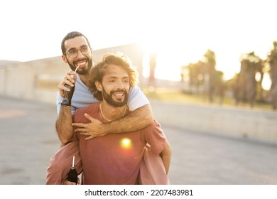 Gay Couple Embracing And Showing Their Love. Young Men Drinking Juice