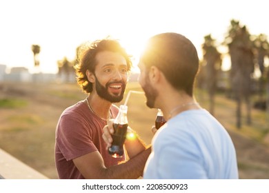 Gay Couple Embracing And Showing Their Love. Young Men Drinking Juice