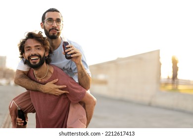 Gay Couple Embracing And Showing Their Love. Young Men Drinking Juice.	