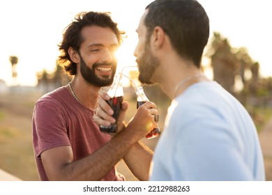 Gay Couple Embracing And Showing Their Love. Young Men Drinking Juice	