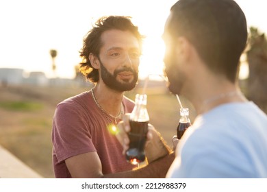 Gay Couple Embracing And Showing Their Love. Young Men Drinking Juice.	