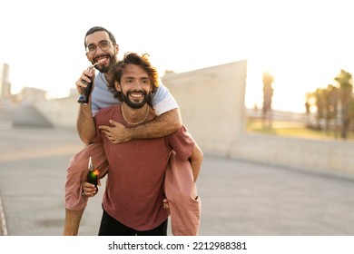 Gay Couple Embracing And Showing Their Love. Young Men Drinking Juice.	