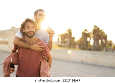 Gay Couple Embracing And Showing Their Love. Young Men Drinking Juice.	