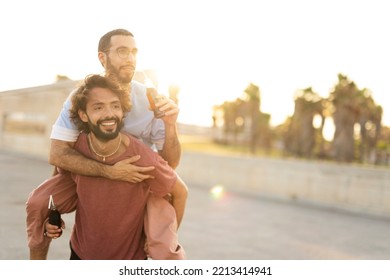 Gay Couple Embracing And Showing Their Love. Young Men Drinking Juice.	