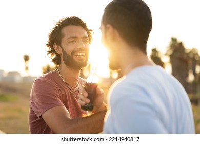 Gay Couple Embracing And Showing Their Love. Young Men Drinking Juice	