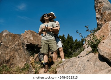 A gay couple enjoys a summer hike, embracing amongst the rocks and trees, creating a loving moment in nature. - Powered by Shutterstock