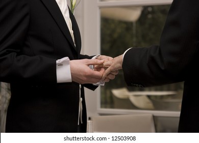 A Gay Couple Exchanging Rings At Their Civil Partnership.