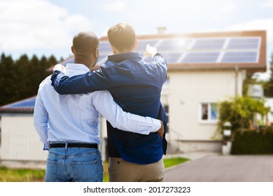 Gay Couple In Front Of New House With Solar Panel Roof