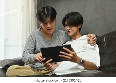 Gay Couple Having An Enjoy Moment With Their Digital Tablet, LGBT Couples And Everyday Life At Home Concept.