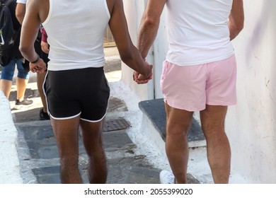 Gay Couple Holding Hands And Walking Outdoors. Mykonos, Greece.