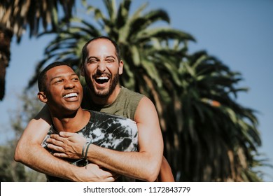 Gay couple hugging in the park - Powered by Shutterstock