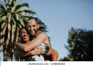 Gay Couple Hugging In The Park