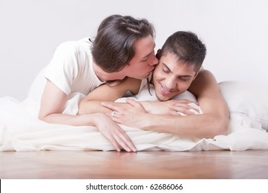 Gay Couple Kissing On The Bed