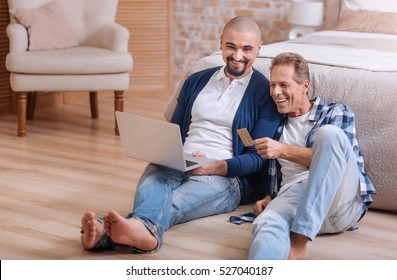 Gay Couple Looking At The Laptop And Having Fun