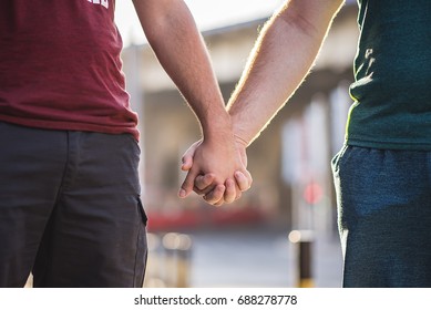 Gay Couple In Love Holding Hands, Walking Down The Street In Summer