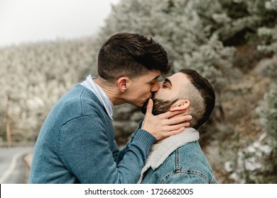 Gay couple in love kissing at the forest in winter - Powered by Shutterstock