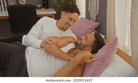 Gay couple lying in bed at home, smiling and looking at each other lovingly, creating a warm and intimate moment in the cozy bedroom setting. - Powered by Shutterstock