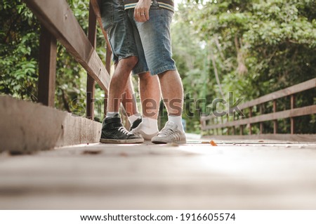 gay couple on the bridge in the park
