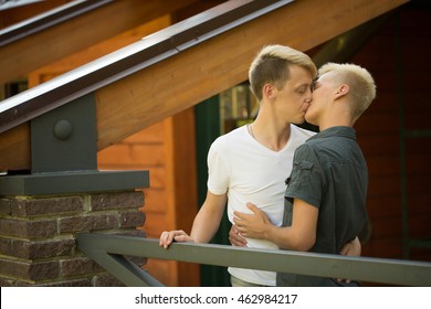 Gay Couple On The Street. Two Men Kissing