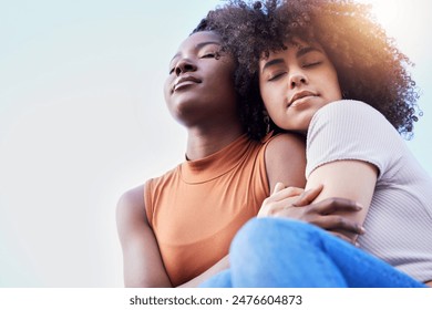 Gay couple, relax and embrace with hug for LGBTQ, pride or love on outdoor freedom together. Interracial, young female person or calm lesbians with smile for romance, care or bonding with blue sky - Powered by Shutterstock