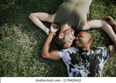 Gay couple relaxing in the grass - Powered by Shutterstock