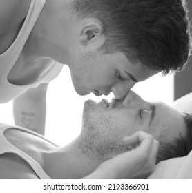 Gay couple relaxing together, LGBT. Two young men kissing and hugging. Black and white portrait. Young men romantic family in love. Happiness concept - Powered by Shutterstock