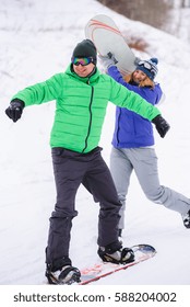 Gay Couple Snowboarders Posing For A Photograph