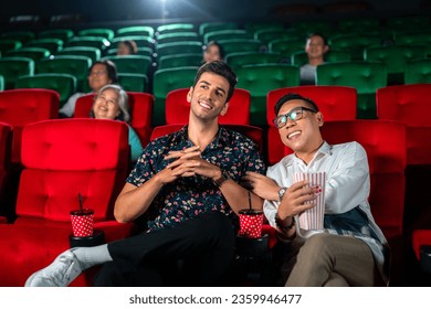 gay couple sweet and watching cinema together on red seat in theater, lgbt couple travel and relax in valentine day - Powered by Shutterstock