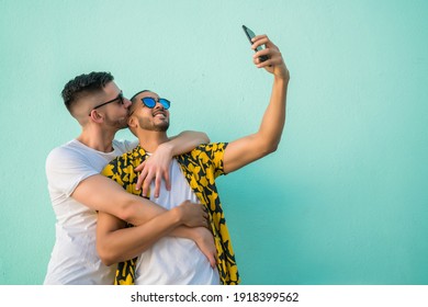 Gay Couple Taking A Selfie With Mobile Phone.