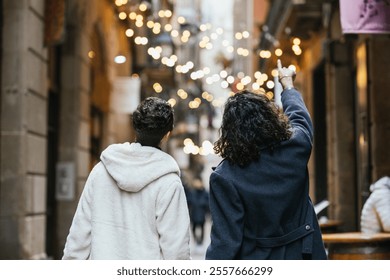 Gay couple walking and pointing at christmas lights in barcelona city center - Powered by Shutterstock