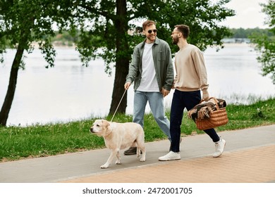 A gay couple walks with their Labrador retriever through a green park, heading towards a picnic spot by a lake. - Powered by Shutterstock