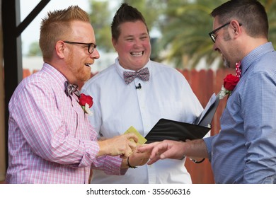 Gay Couple In Wedding Ring Ceremony With Minister