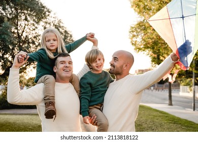 Gay Fathers And Children Playing Together At City Park - LGBT Family Love Concept - Main Focus On Left Man Face