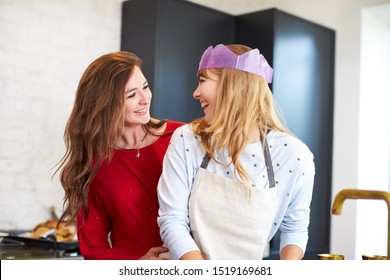 Gay Female Couple At Home In Kitchen Washing Up After Dinner On Christmas Day