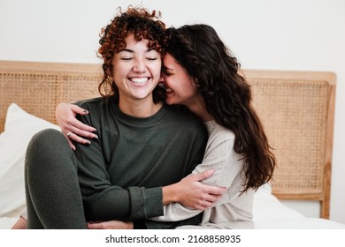 Gay female couple surprising lover with engagement ring in bed at home - Lgbt lesbian love and romance concept - Focus on left woman face - Powered by Shutterstock