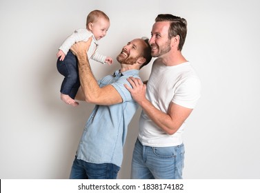 Gay Or Homosexual Male Couple With Their Daughter Baby Over White Background