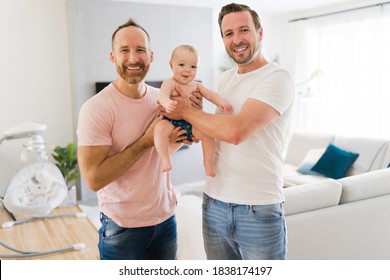 Gay Or Homosexual Male Couple With Their Daughter Baby At Home.