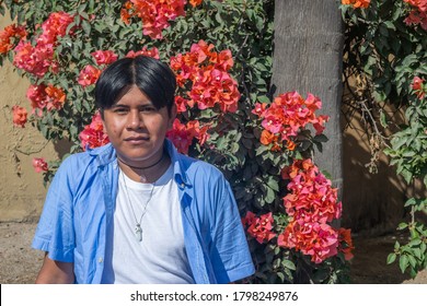 Gay Latin Teenager Among Red Flowers